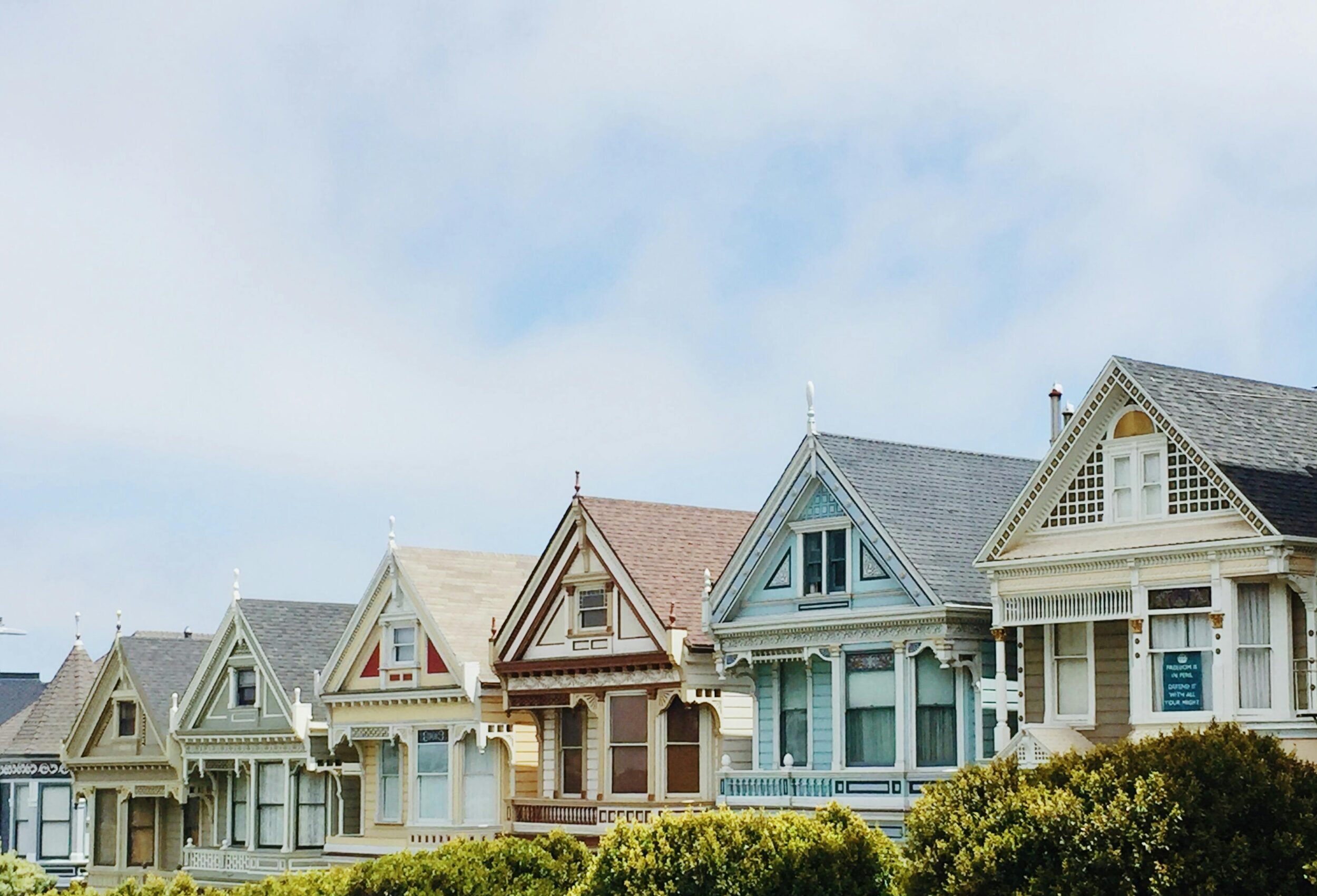 Iconic Painted Ladies Victorian houses in San Francisco with clear blue skies.